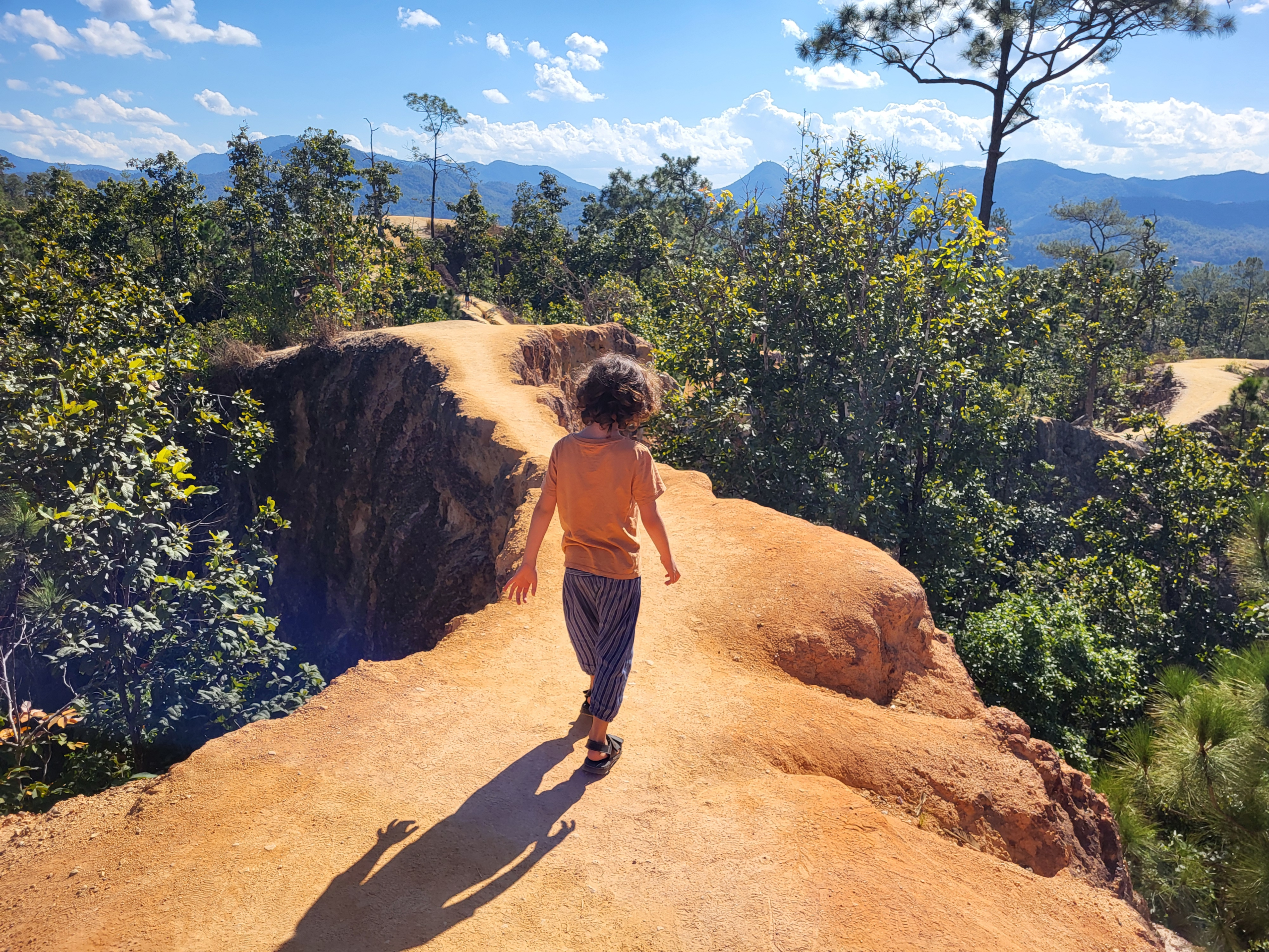 Child walking along path travelling in Thailand